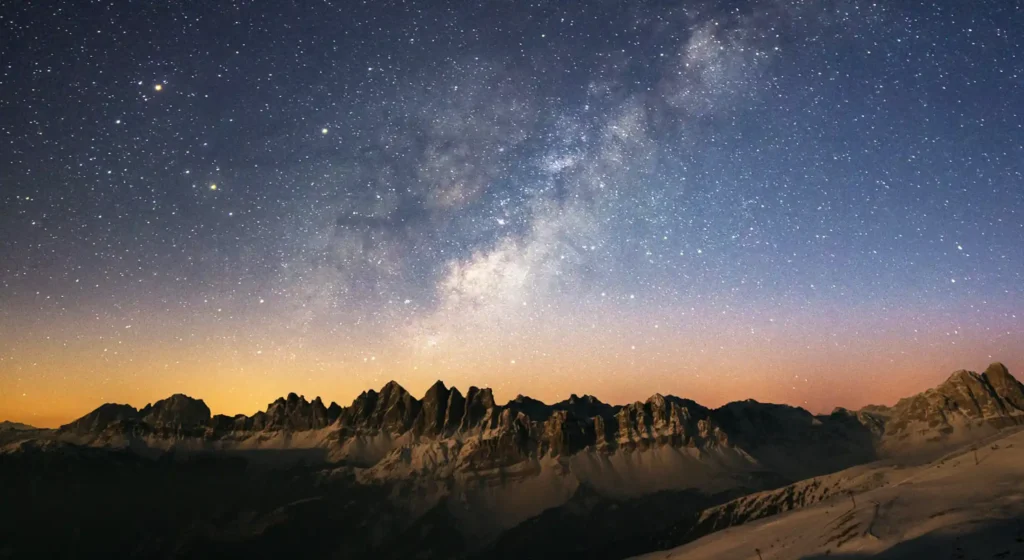 signs from the universe stars and nebula shown above a mountain range