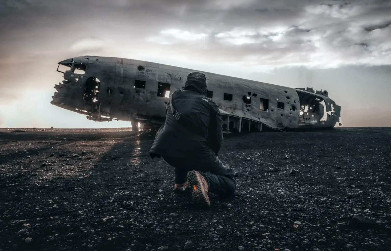Man stands by an old wrecked plane signs of past life trauma