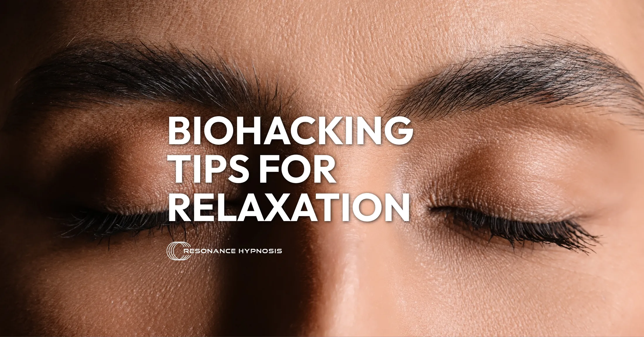 close up image of a woman with her eyes closed - text overlay reads "biohacking tips for relaxation"